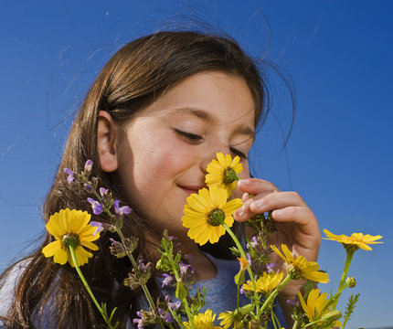 Young Girl Smelling Flowers