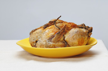 Grilled chicken on the yellow plate.