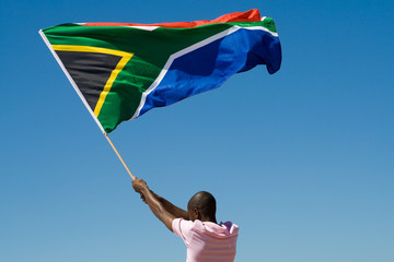 african man waving a south african flag - obrazy, fototapety, plakaty