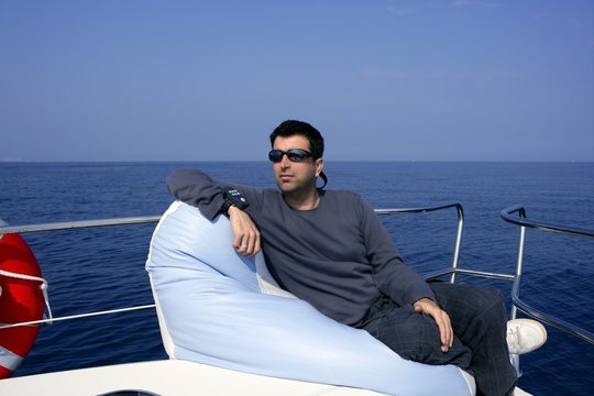 Man on bow boat relaxed on bean bag