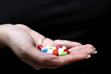 Female hand with colorful pills