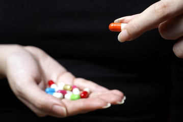 Female hands with pills