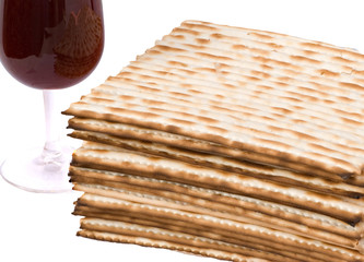 Close up of matza and goblet with red wine