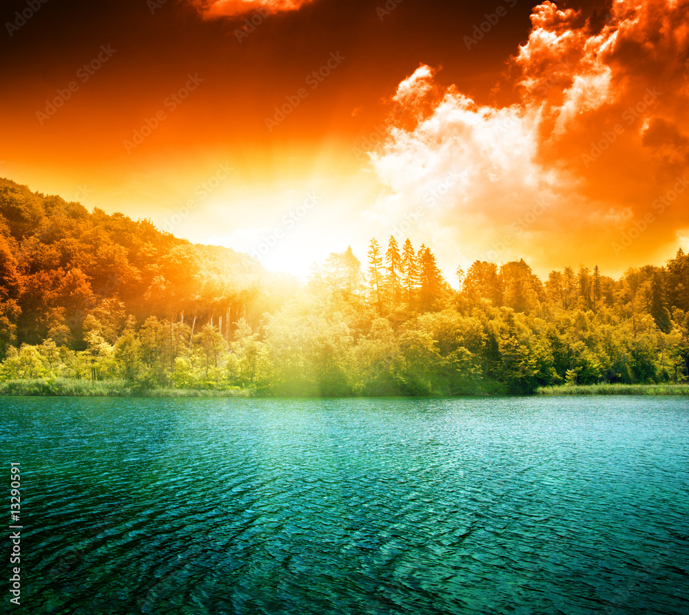 Wall mural green water lake and sunset