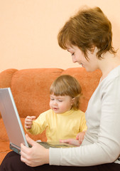 Small girl and mother with laptop