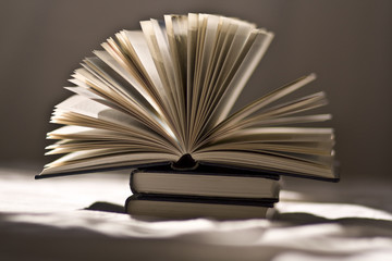 open book on top of closed books