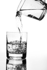 Water jug pouring into glass