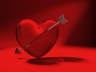 glass heart and cupid arrow on red