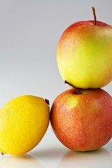 Lemon and apples on neutral background