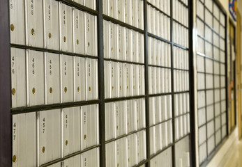 A row of post office boxes in a small rural post office.