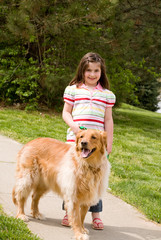 Girl Walking Down the Sidewalk With Dog