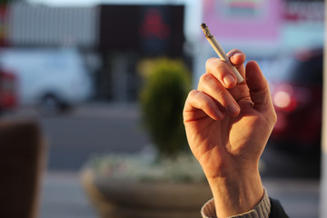 Hand with smoking cigarette