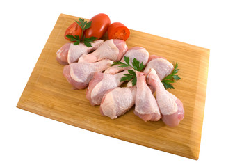 Chicken Legs on wooden board over white
