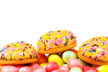 Sweet cakes and colourful gums at the background