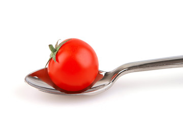 single tomato on spoon