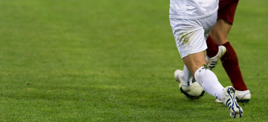 Soccer players running after the ball