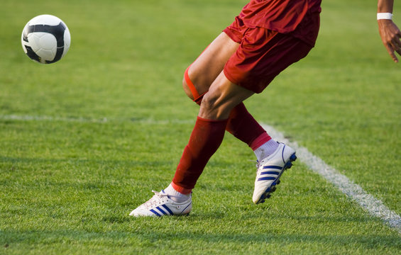Fototapeta Soccer player running after the ball
