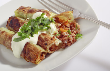 Rolled pore's leaves with cream (creme fraiche) and basil