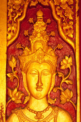 Fototapeta na wymiar Traditional Thai style Buddhist church door wood carving