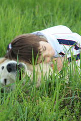 Girl and dog in grass
