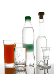 Different drinks in bottles and glasses