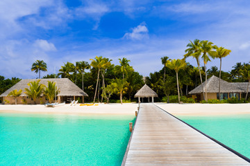 Fototapeta na wymiar Beach bungalows on a tropical island