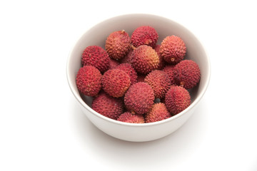 Bowl of Lychees isolated on a white studio background.