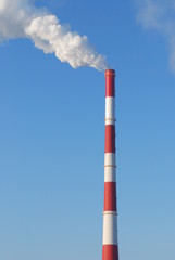 Smokestack in a blue sky background