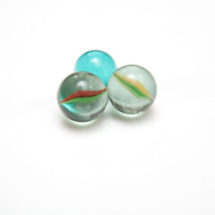 Glass marbles isolated on a white studio background.