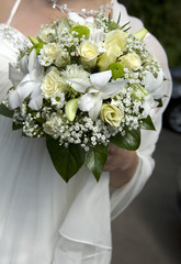 Bride in dress holding beautiful bouquet of rose