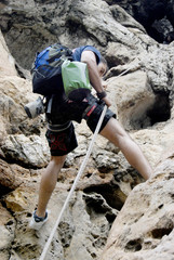 Young man rappeling from a cave in Thailand