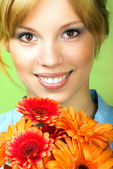 Fototapeta premium Beauty portrait of a young woman with a flower