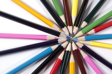 Fototapeta premium Colored pencils organized in a nice way on a while background.