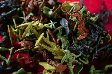 Metaphor of dead plastic toy war soldiers