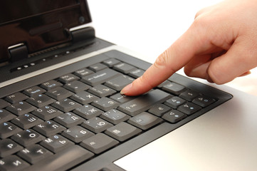 finger typing on a laptop