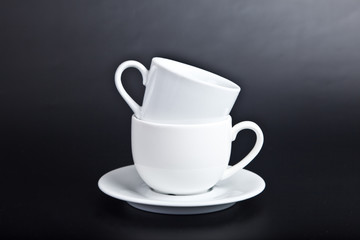 Two cups of white on a black background