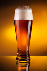 Glass of beer with froth, close-up