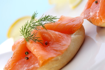 Smoked salmon on bagel with fresh black pepper.