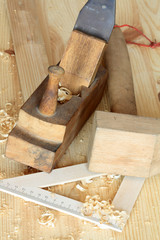 Carpenter's hammer plane ruler on wooden background