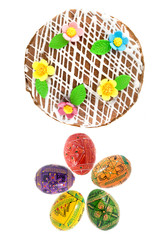 top view of easter eggs and cake isolated on white
