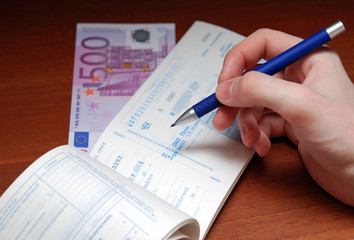 8.	Extract of the check with a banknote on a wooden background