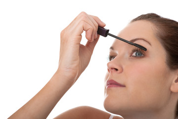 Body care series - Young brown hair woman applying mascara