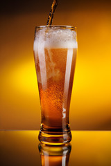 beer pouring into a glass