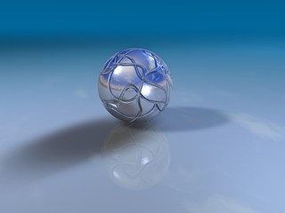 Reflective silver ball on a shiny surface