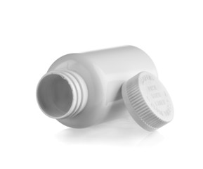 Open white medicine bottle lay down