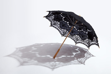 Black lace parasol with shadow - obrazy, fototapety, plakaty