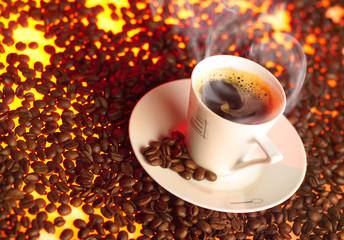 Cup of coffee over toasted coffee beans