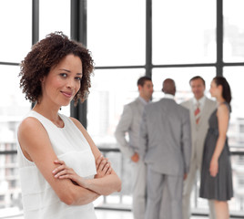 Business woman smiling in from of Business team