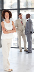 Business woman with Folded arms in Front of Business team