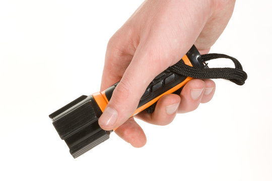 Black and orange flashlight held in hand